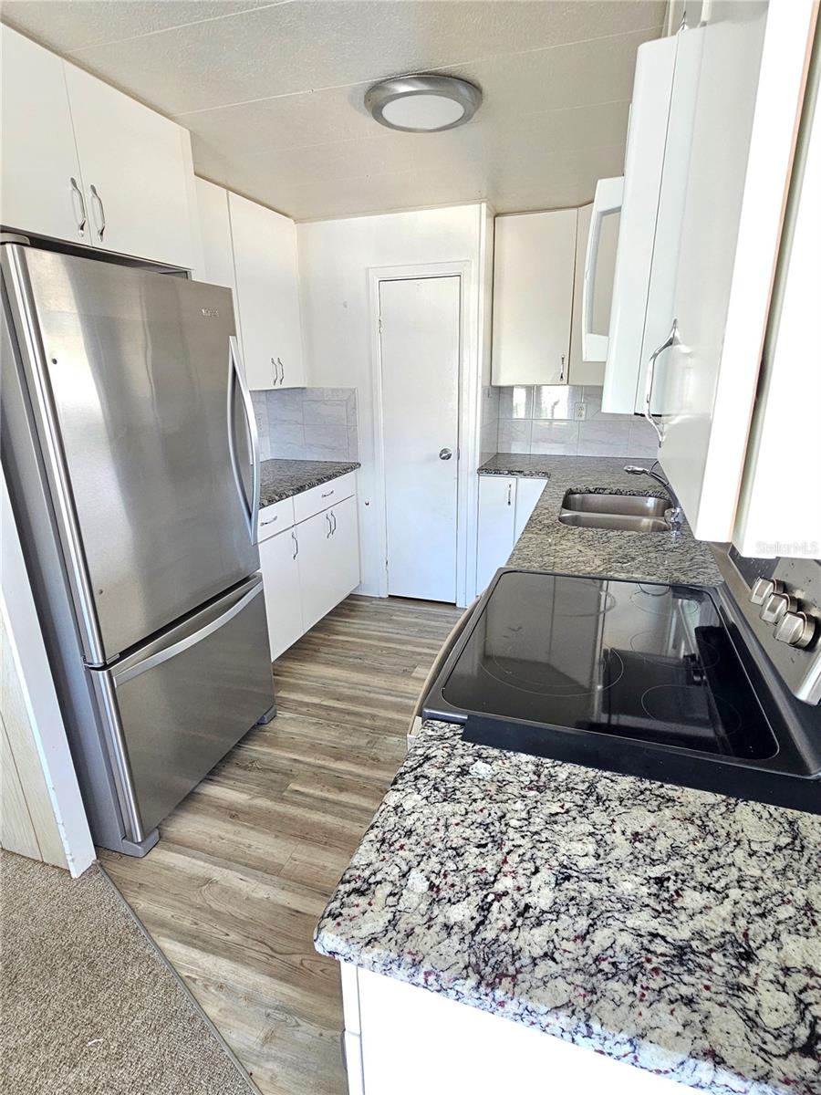 Kitchen with granite counters and stainless appliances
