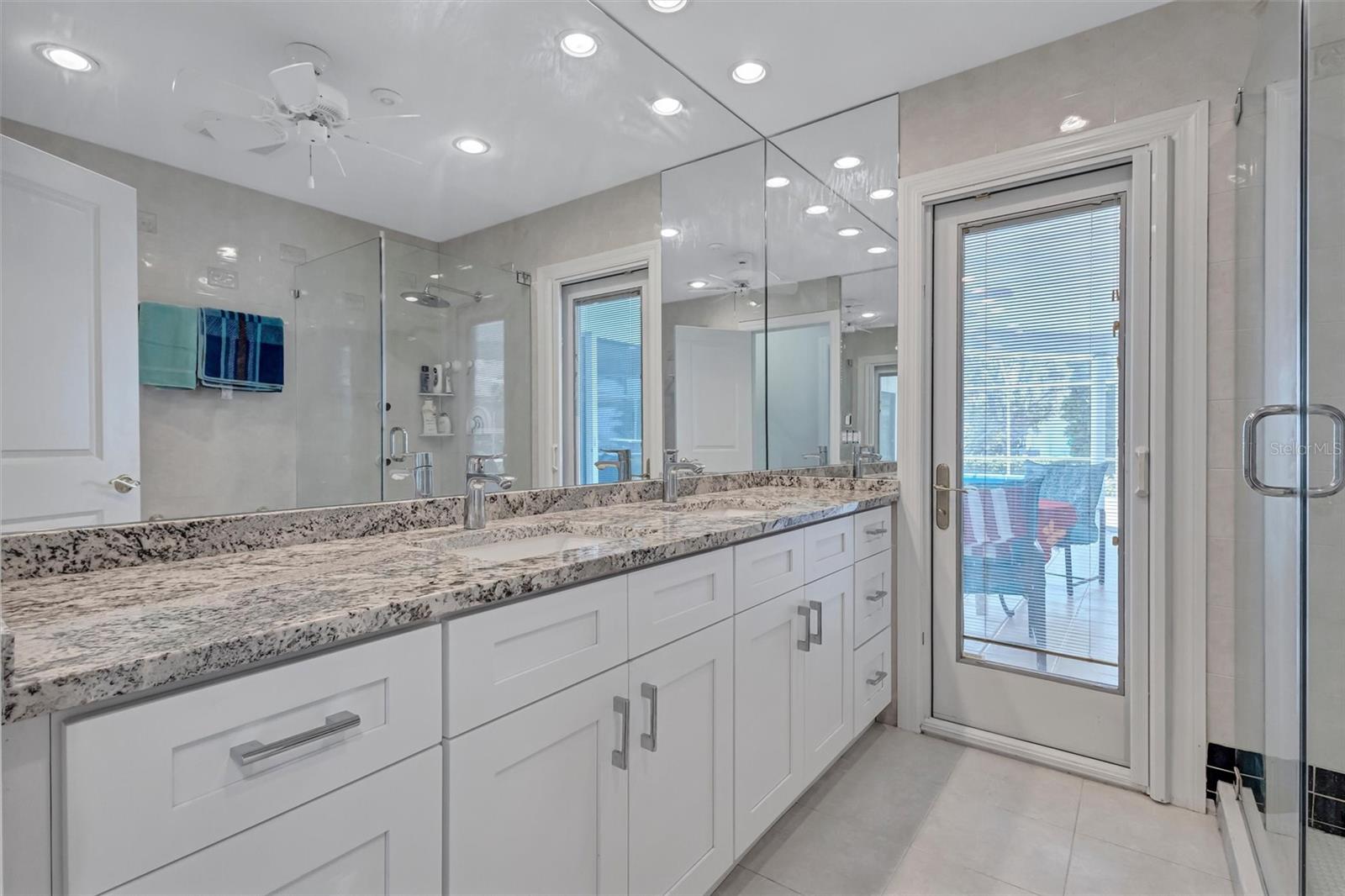 Primary bath with door to pool and lanai.