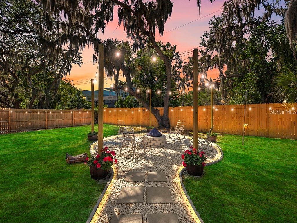 Firepit and lighting at night. Digitally enhanced lawn.