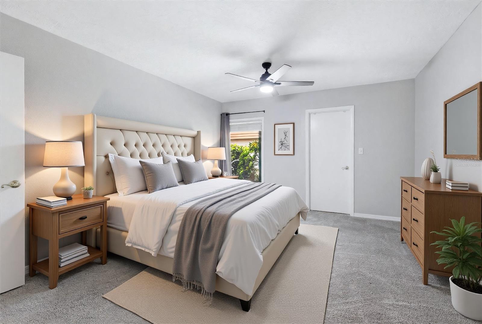 Primary bedroom w/ walk in closet, en suite bath and slider- Virtually Staged