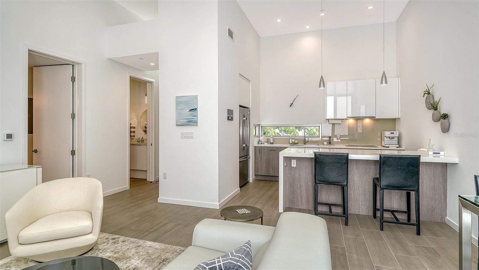 Spacious living room with dining area and seating at kitchen island.