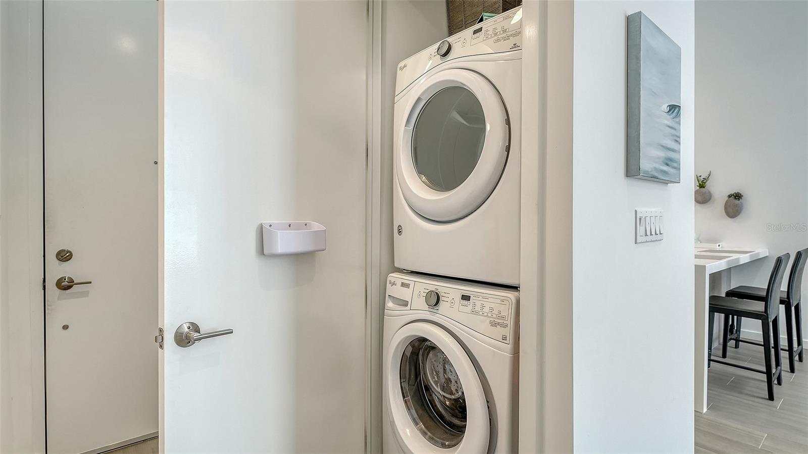 Conveniently stacked washer and dryer are ready for usage.