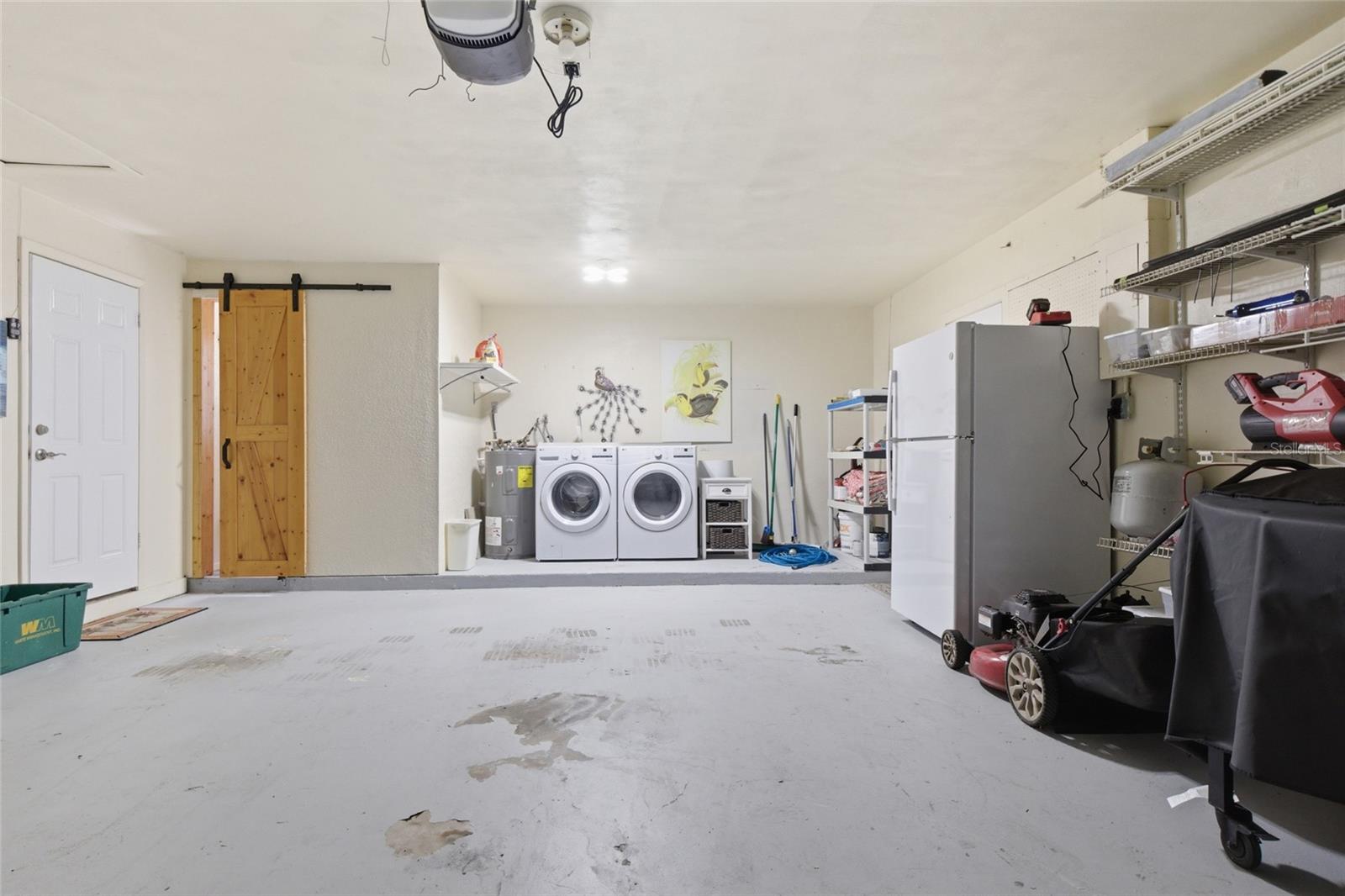 Two stall garage with bathroom, washer, dryer, extra refrigerator