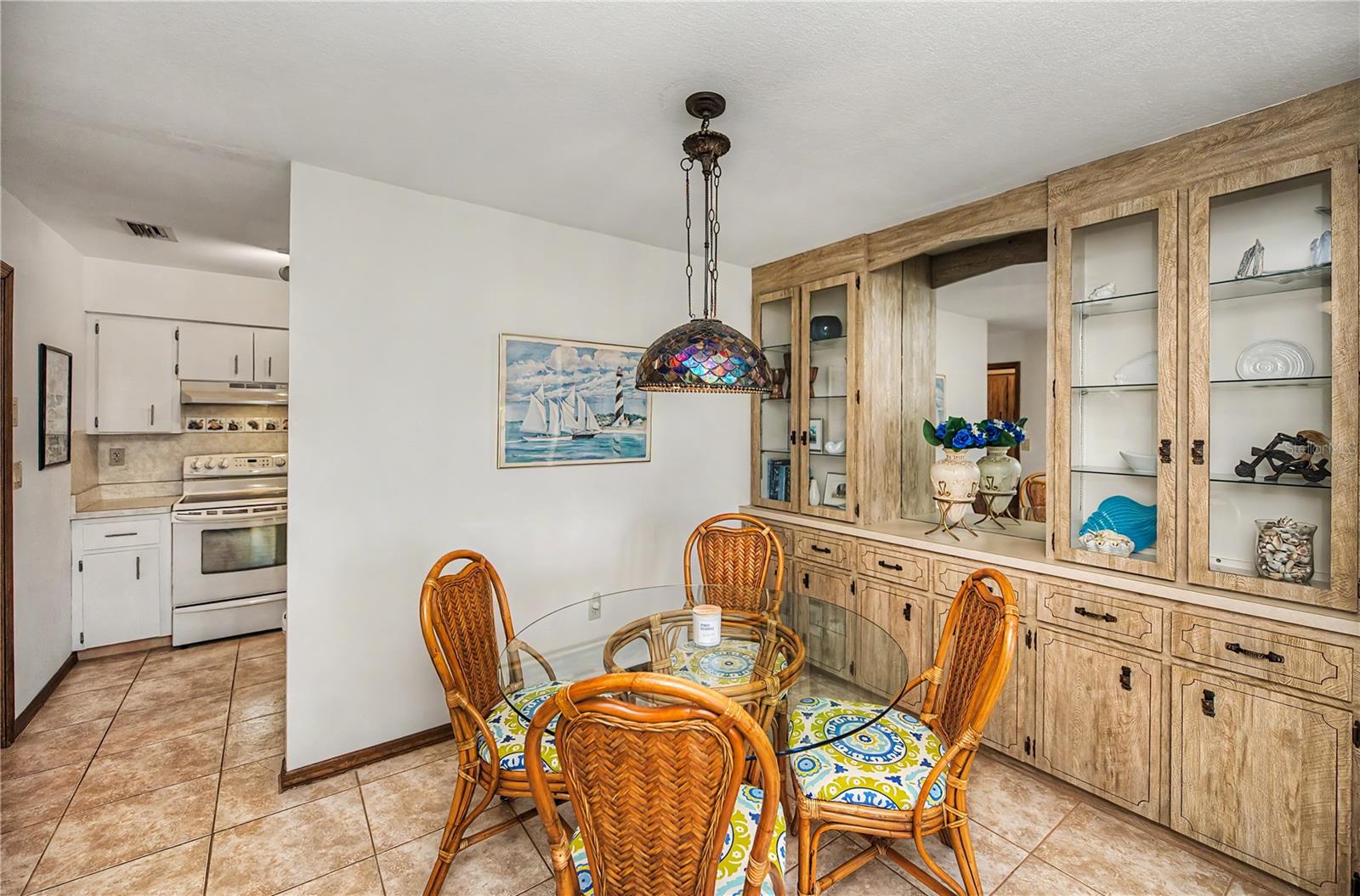 Easy Kitchen Access from Dining Area with Built In Display Cabinet.
