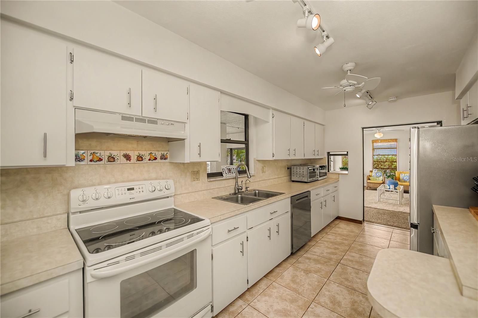 Galley Kitchen with Abundant Cabinetry, Ample Counter Space.