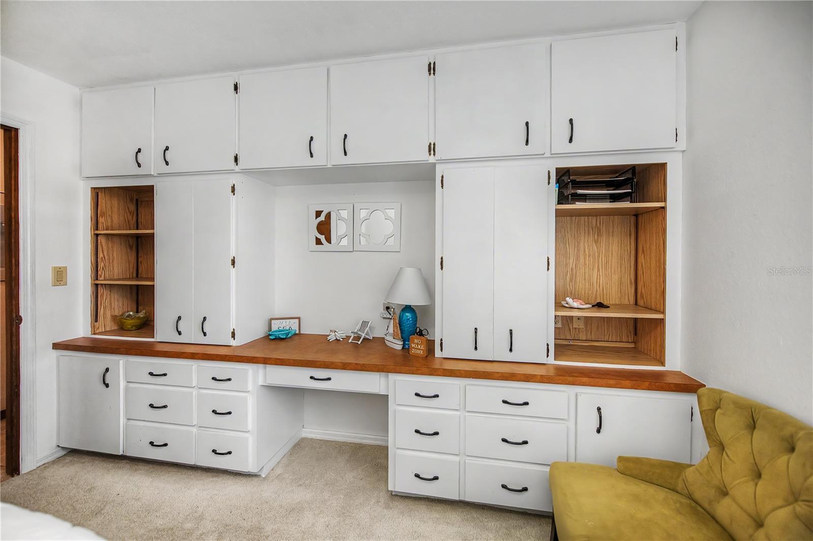 Guest Bedroom With Built-In Office Nook with Ample Storage Space.