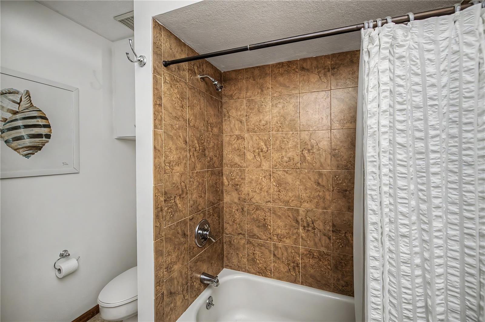 Guest Bath with Tile Tub/Shower Combo.