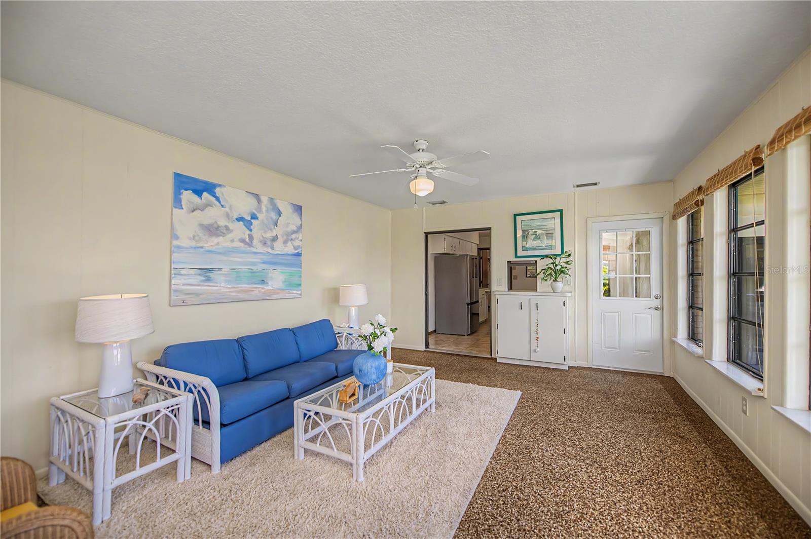 Florida Room, with Comfortable Seating and Peaceful Backyard Views.