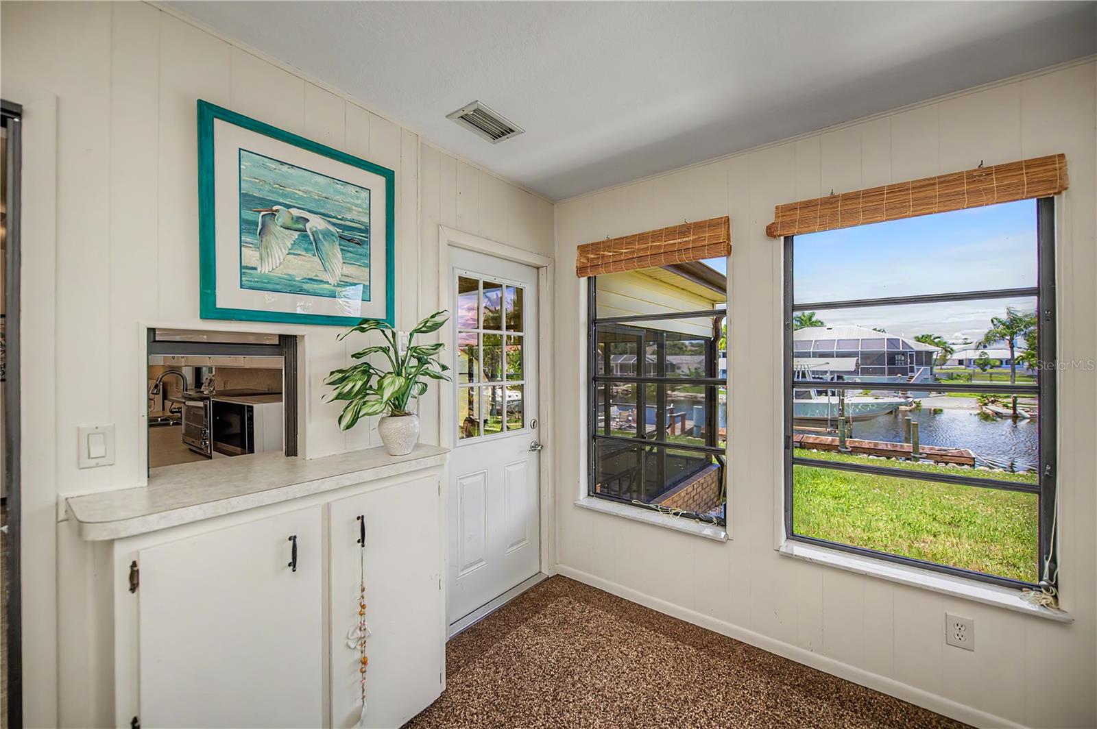 Florida Room Nook with Built-In Storage and Scenic Canal Views.