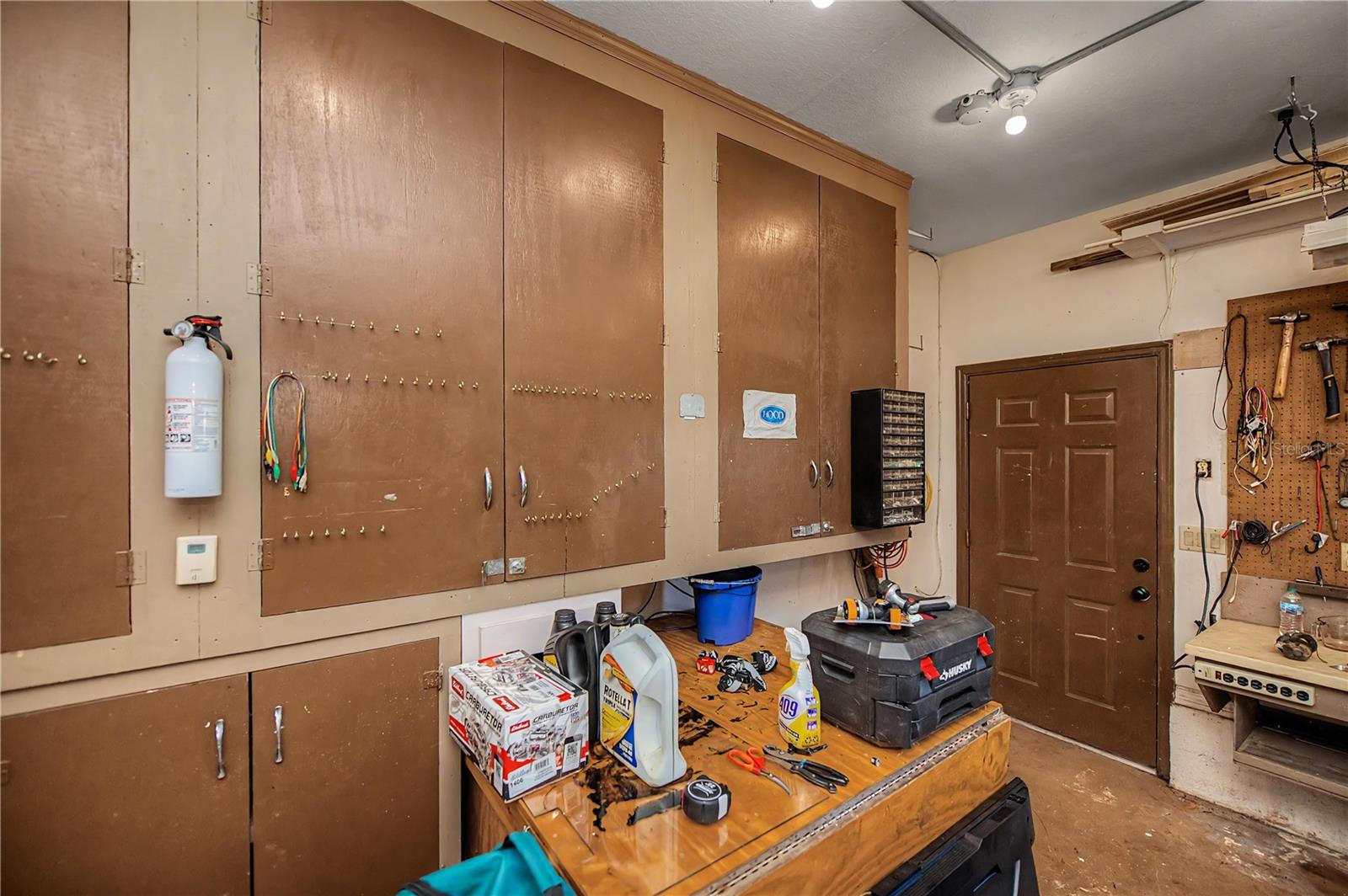 Garage with Extensive Built-In Cabinetry.