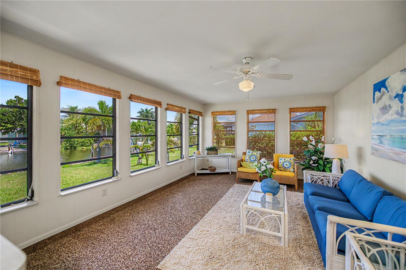 Bright Florida Room with Panoramic Water Views and Abundant Natural Light.