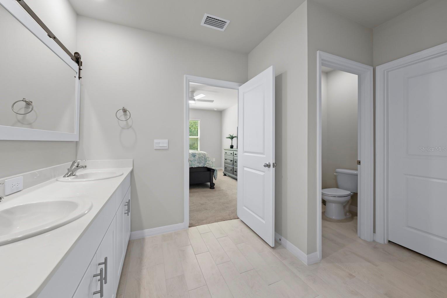 Primary bathroom cont. with private water closet and large walk-in closet.