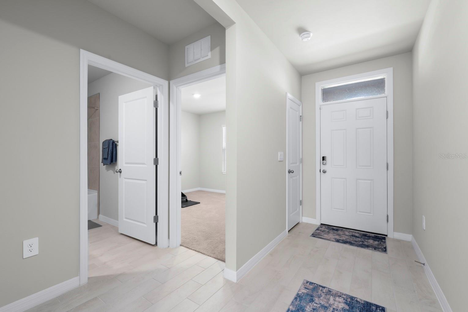Entry foyer with 2 guest bedrooms and bathrooms at the front of the home.