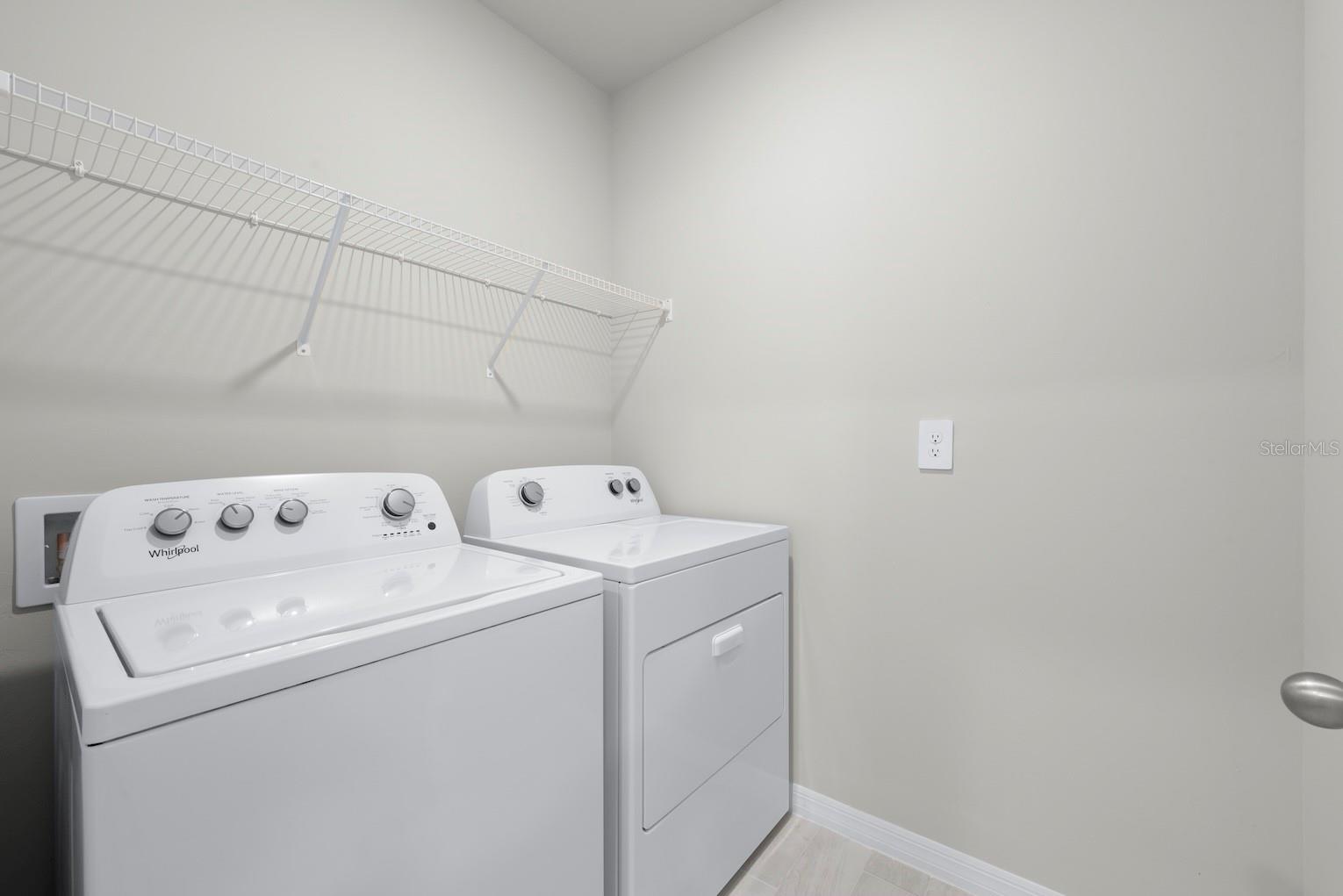 Laundry room with wire shelving.