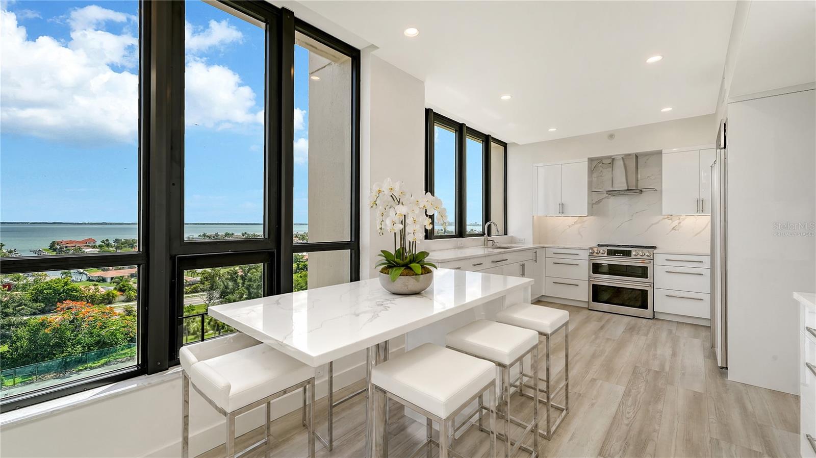 Kitchen island with gorgeous bay views. Virtually staged