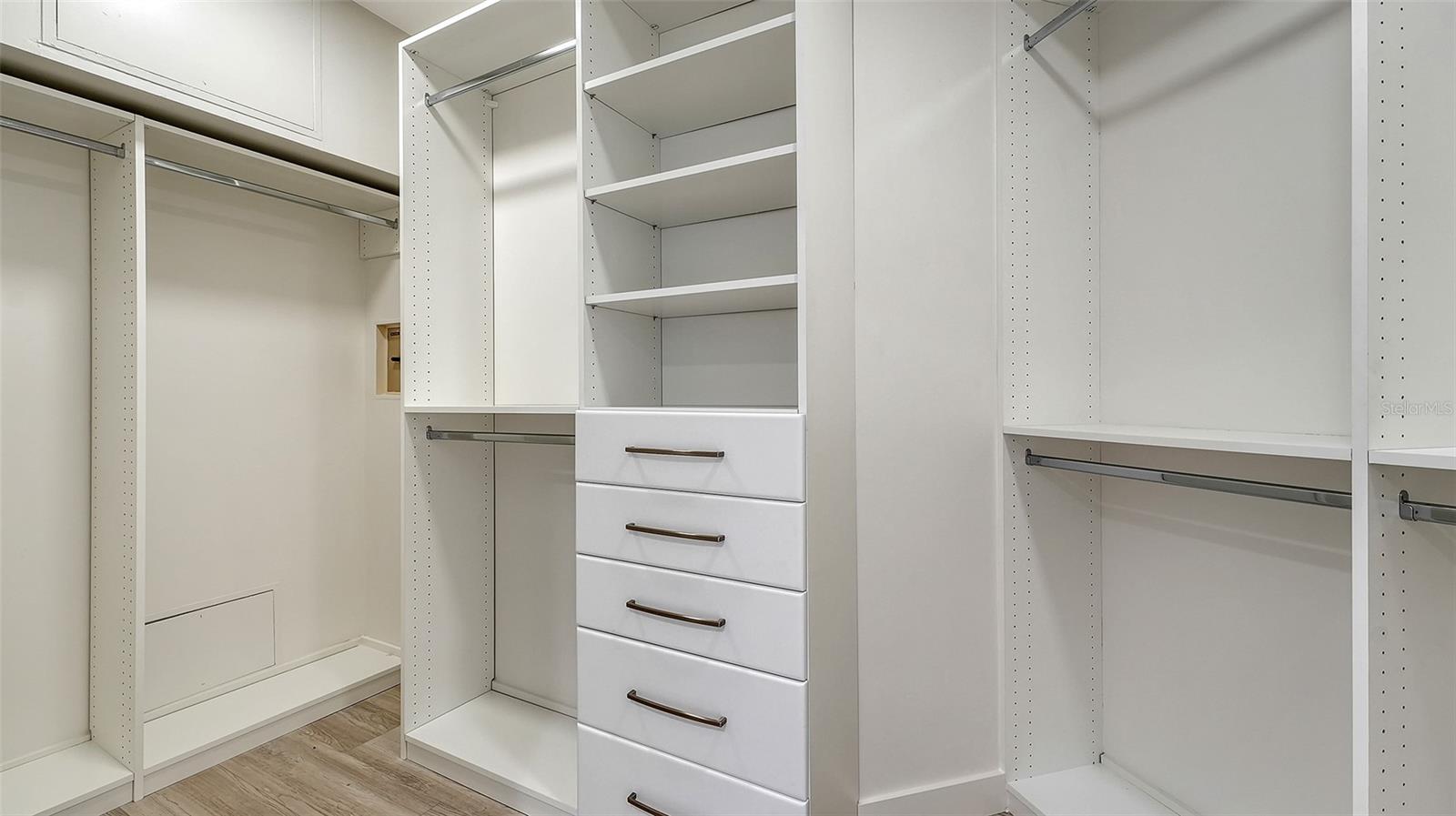 Primary bedroom walk-in closet