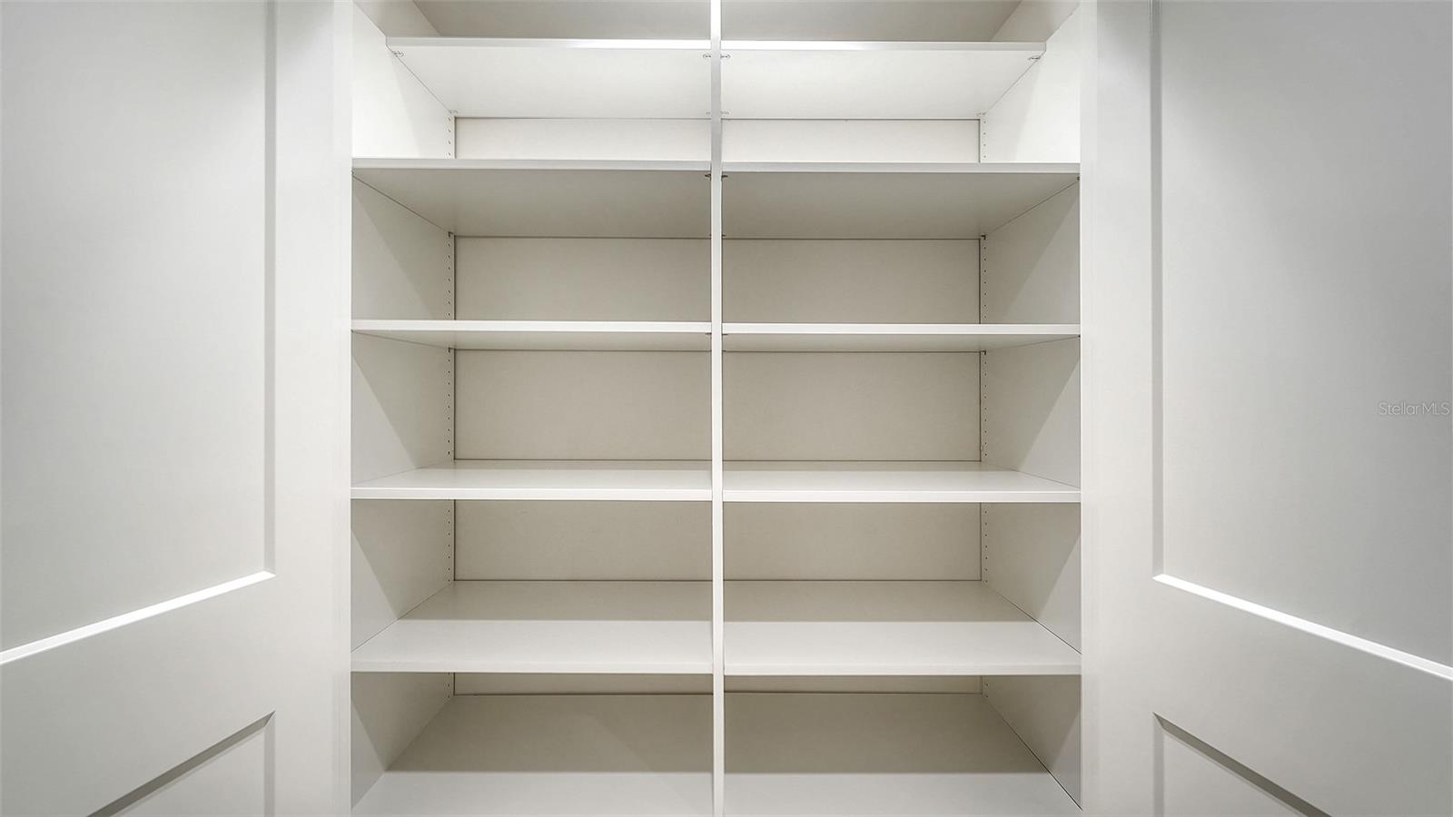 Primary bedroom walk in closet