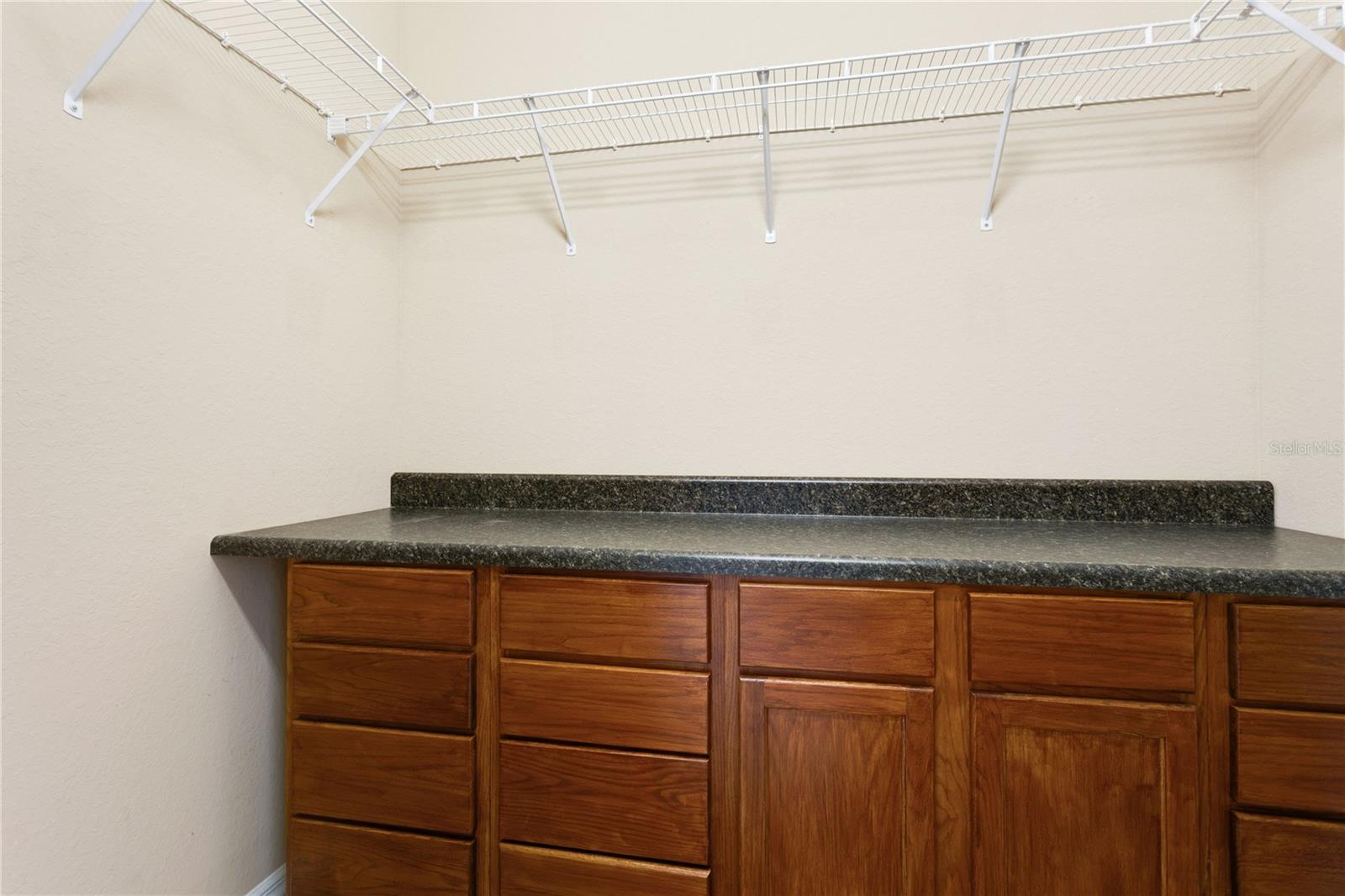 Primary walk in closet with built ins