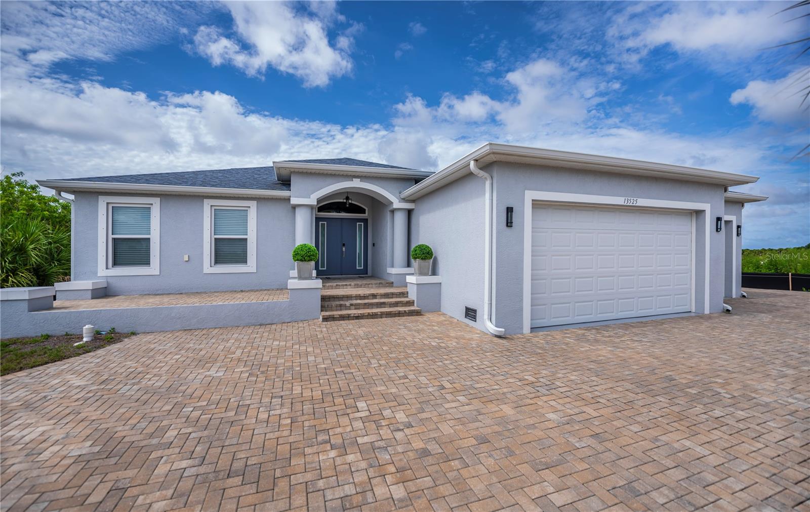 Impressive Curb Appeal with 3 Car Garage & Paver Circular Driveway, Grand Entry, and Oversized 3 Car Garage.
