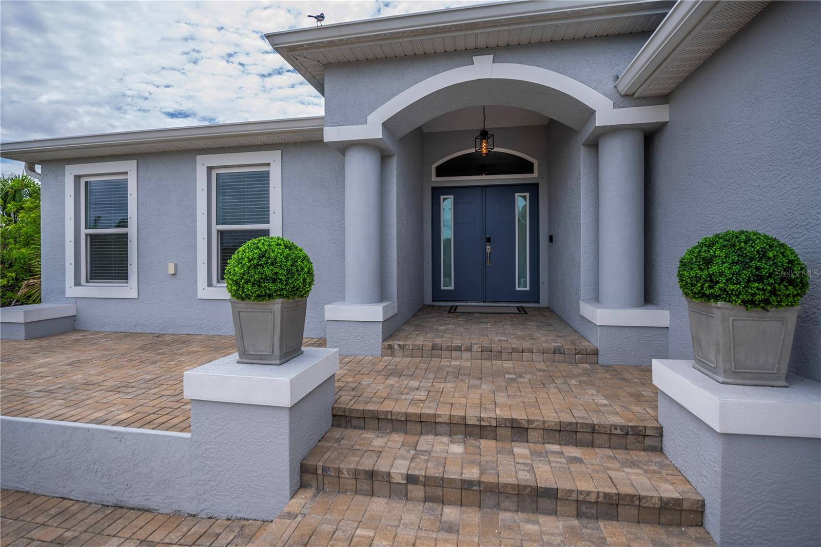 Grand Covered Entryway with Elegant Columns and Welcoming Architectural Details.