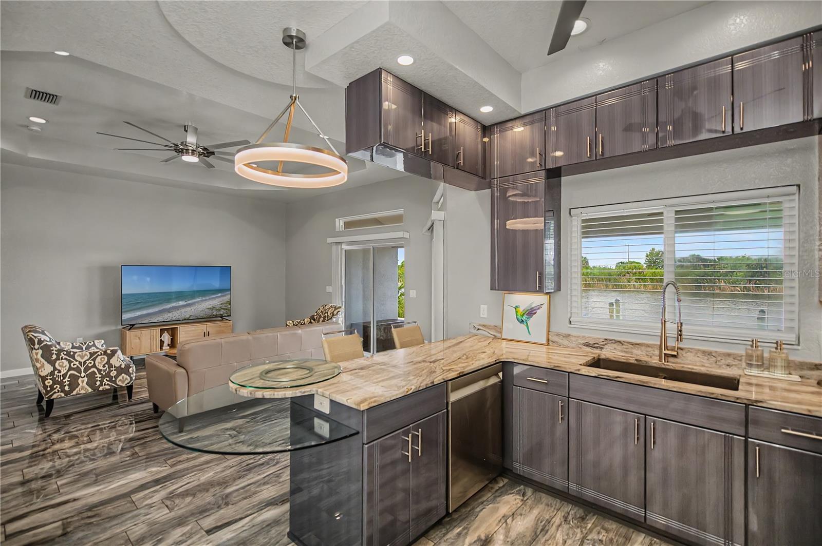 Gourmet Kitchen with Imported European Cabinetry, Stone Countertops, and Waterfront Views.