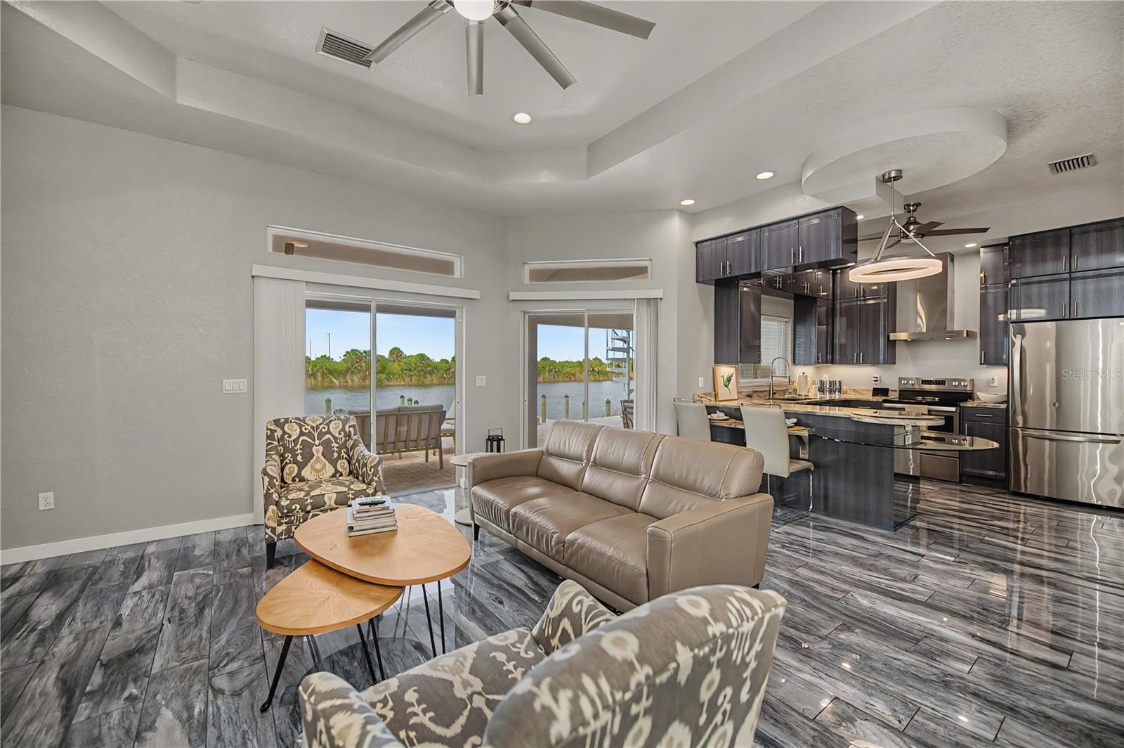 Bright Open Concept Living Space with Soaring Ceilings and Stunning Waterfront Views.