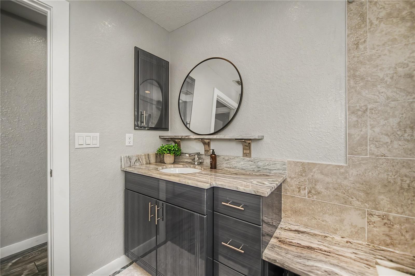 Modern Guest Bath with Stylish Vanity, Stone Countertops, and Designer Finishes.