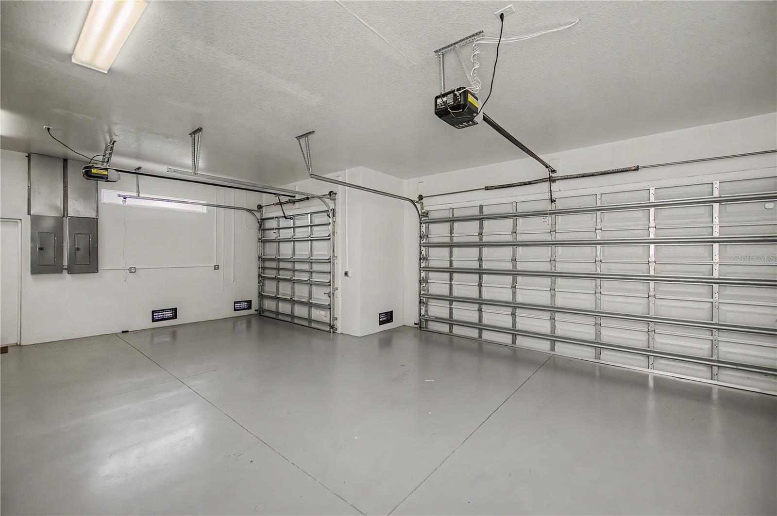 Oversized 3-Car Garage with Epoxy Floors and Ample Storage Space.