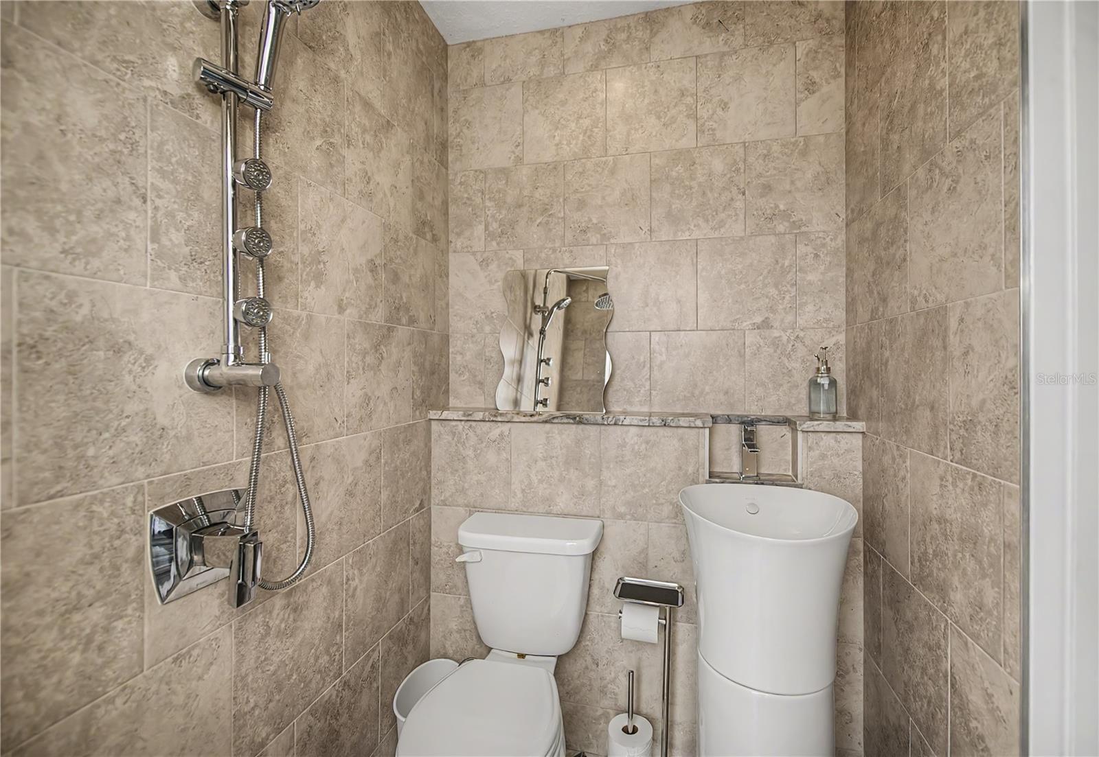 Patio Bathroom Featuring a Vessel Sink, Elegant Telework, and Contemporary Fixtures.