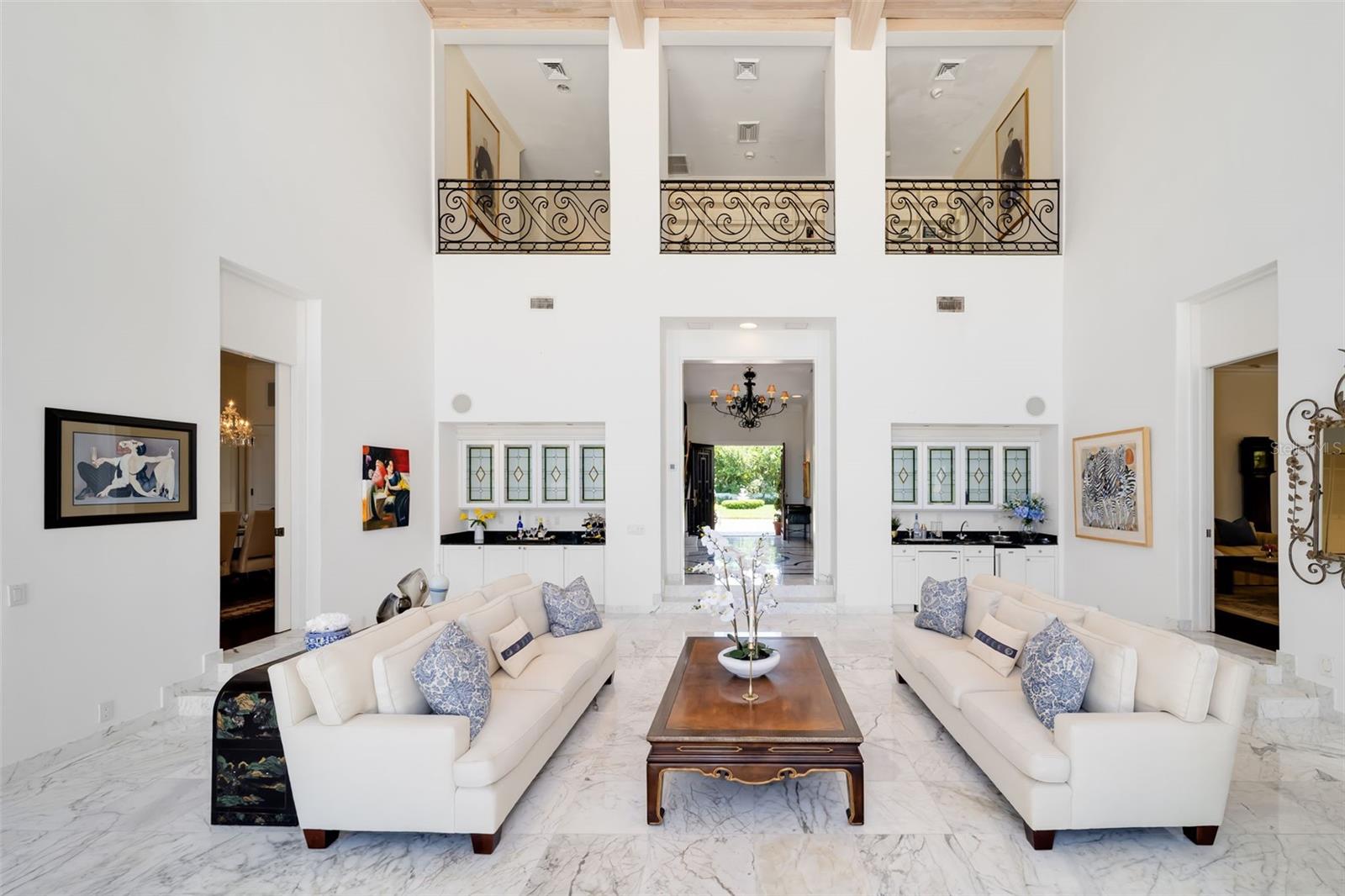 The two wet bars in the gathering room for entertaining, the foyer and the formal dining and formal living rooms flow into the main gathering room for overflow and all heads to the outdoors.