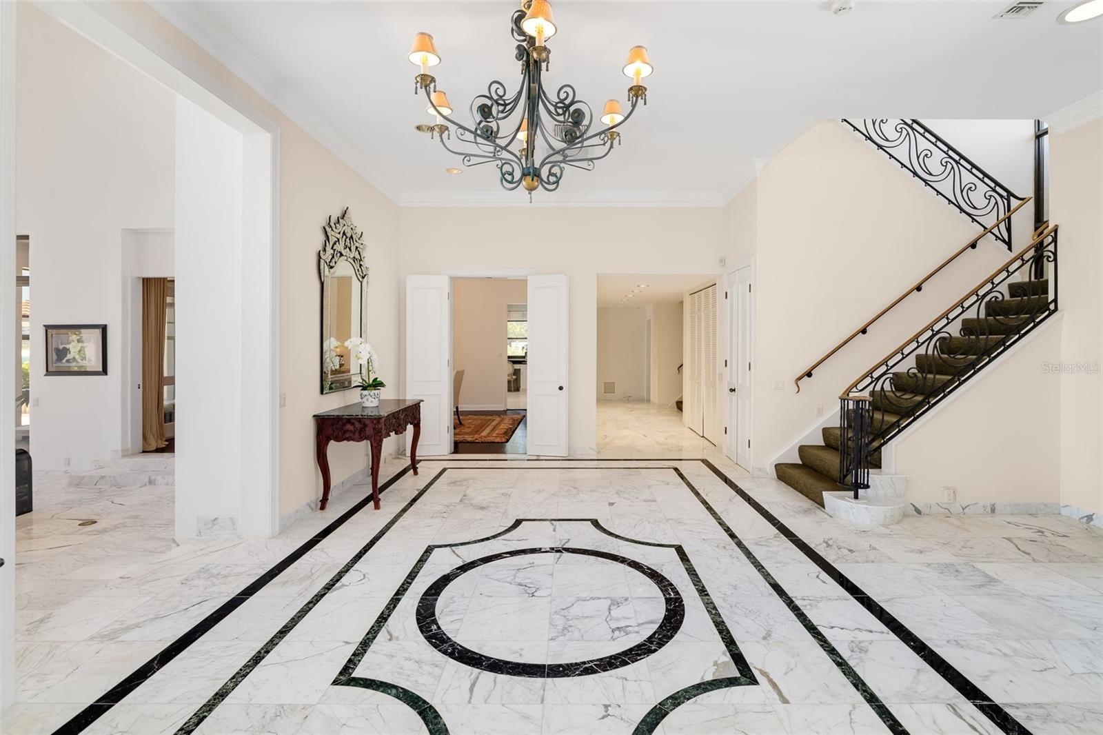 One of the 2-Staircases, the main entrance to the formal dining room off the foyer and the hallway down to the billiards room, Kitchen and downstairs ensuite bedroom.