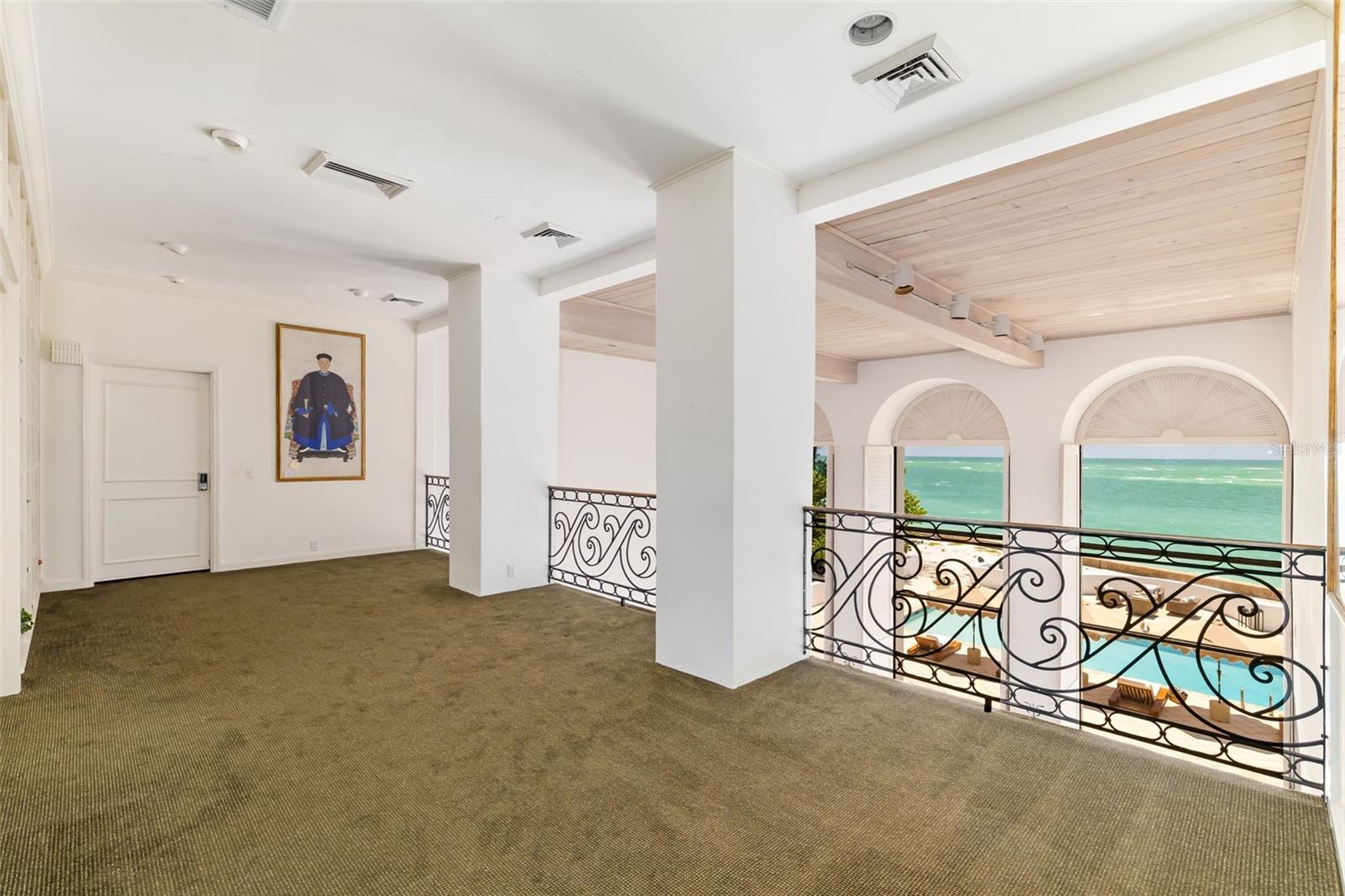 Primary Bedroom with ensuite and walk-in closets behind closed door, walk out terraces overlooking ocean. There is great wall space throughout the home for displays of art collections