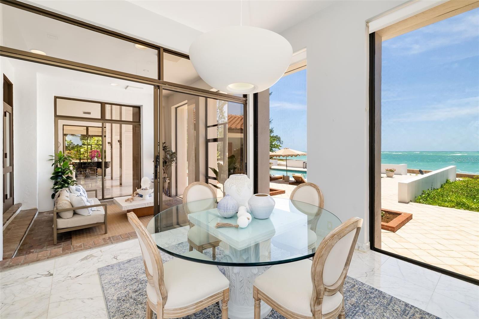 Here you can see the relaxing flow of the covered and screened terrace off the eat-in kitchen.  It also flows through from the formal dining room and the gathering room for those large groups and gorgeous Florida nights