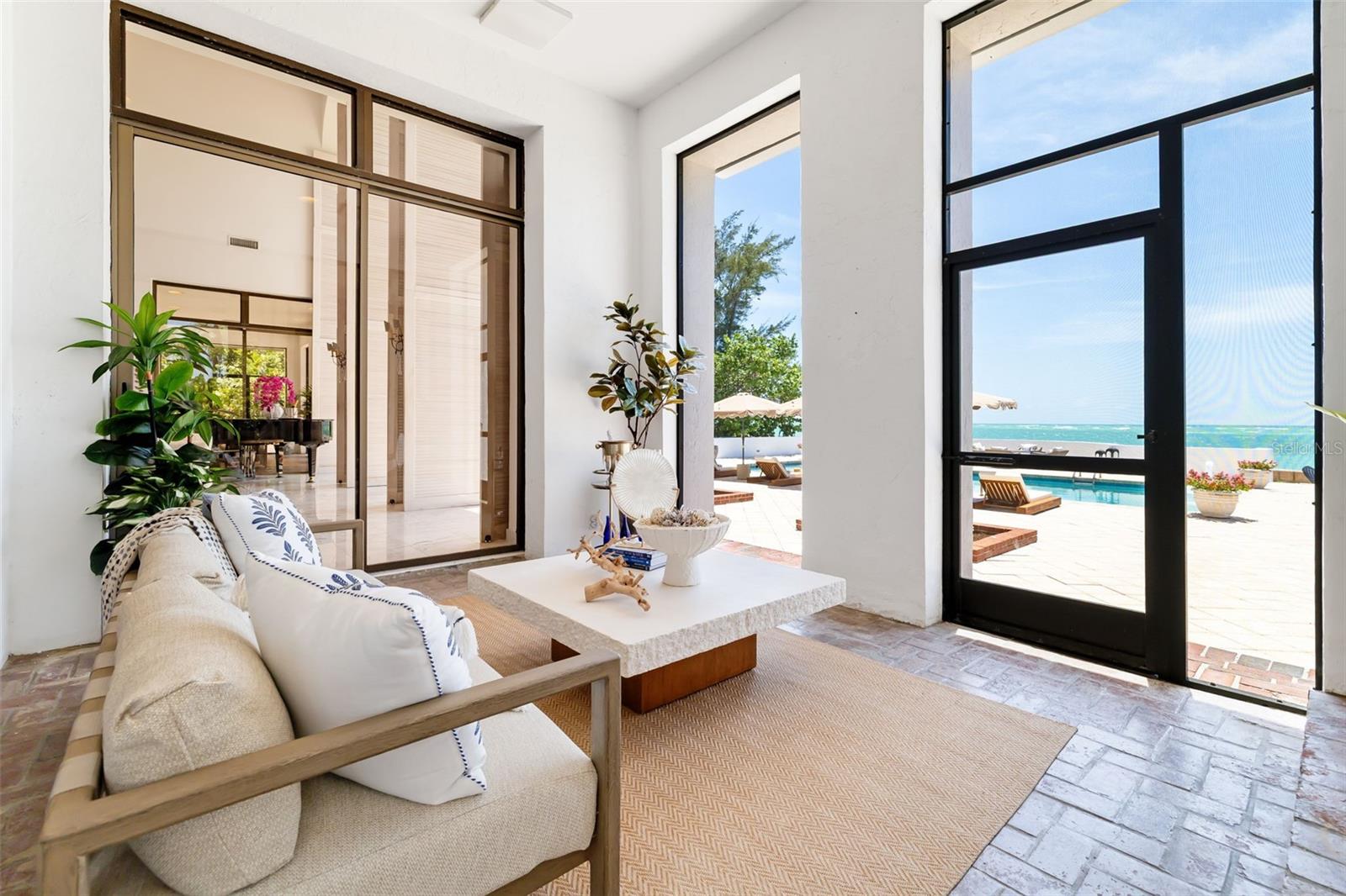 Covered and screened lower terrace flowing out of 3 main rooms to the stunning views... you can get here from the gathering room, the formal dining room or the eat-in kitchen...