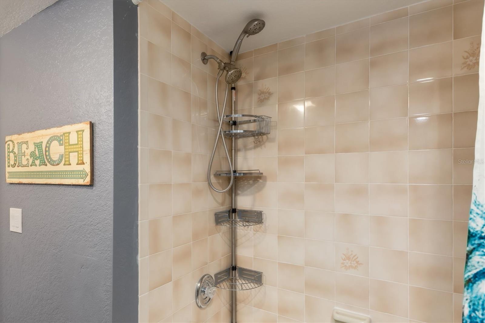 Tub shower combo with spa style fixtures.