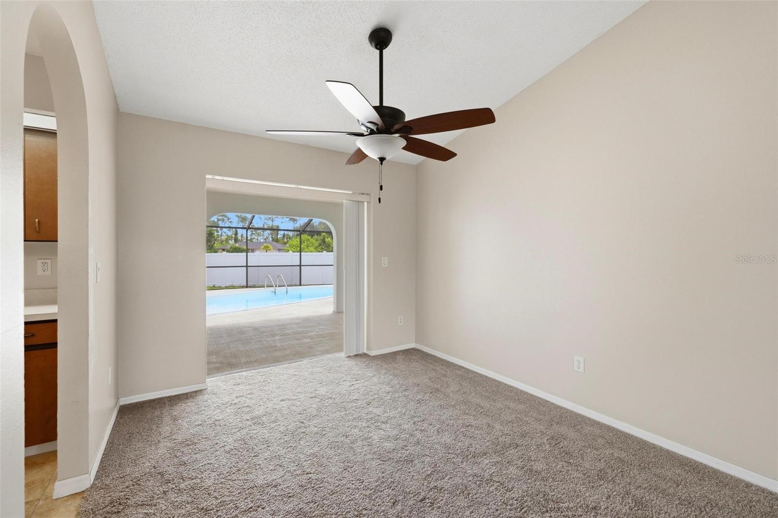 Formal dining room with pocket sliding glass door out to your screened/covered Lanai and private swimming pool