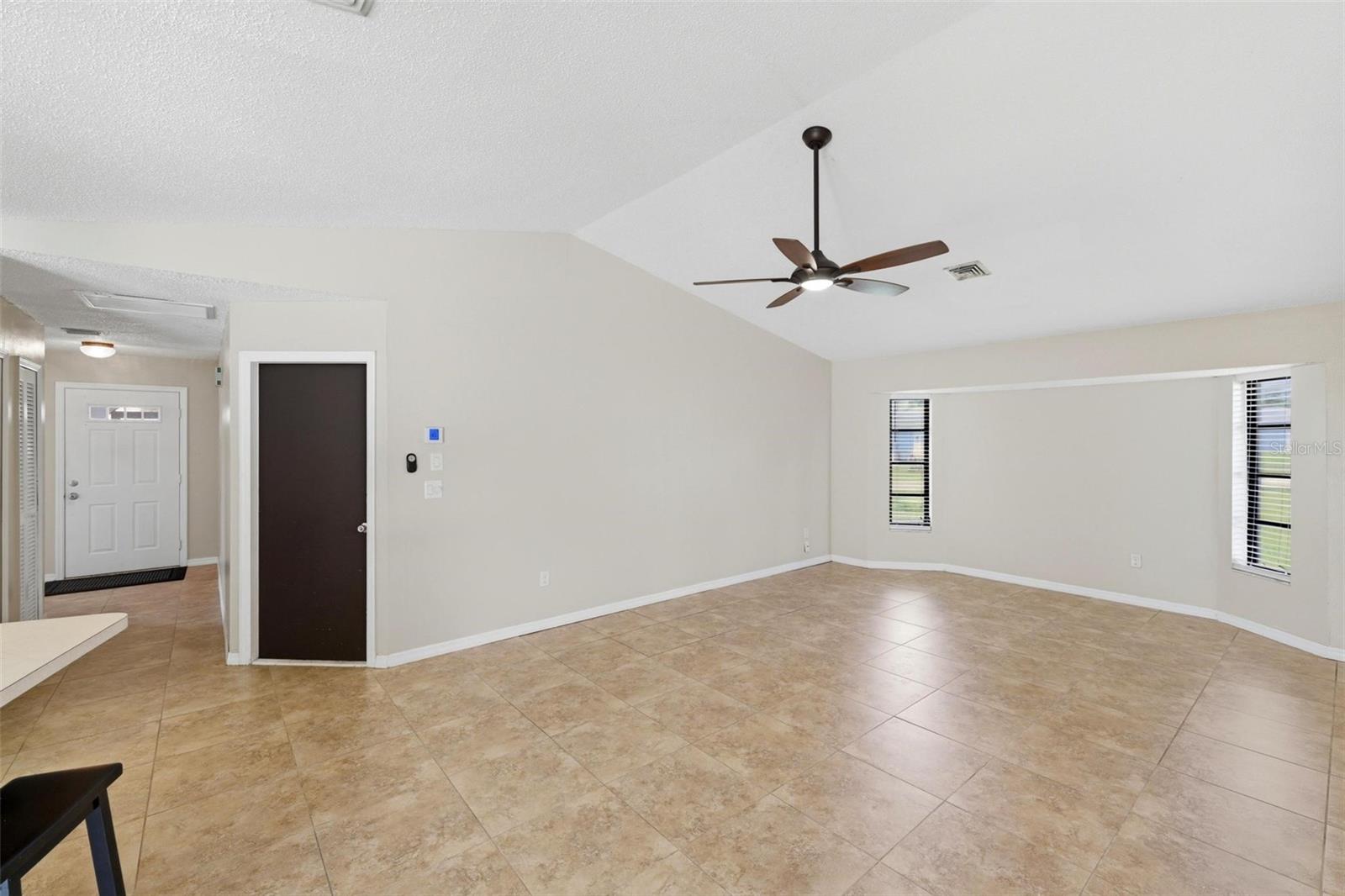 Family room with dark door leads out to the 2 car garage...