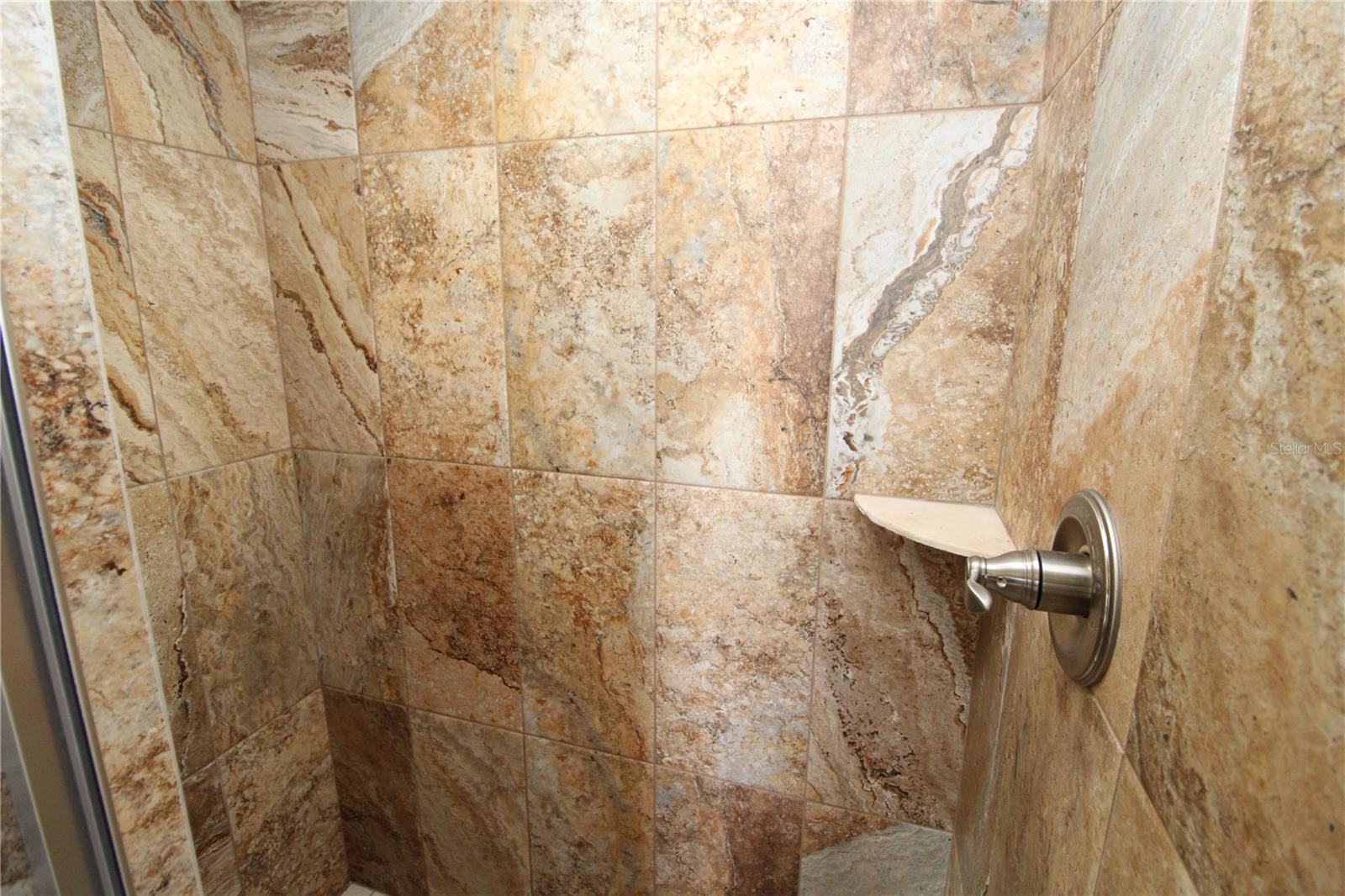 Primary Bathroom walk-in shower is beautifully tiled....