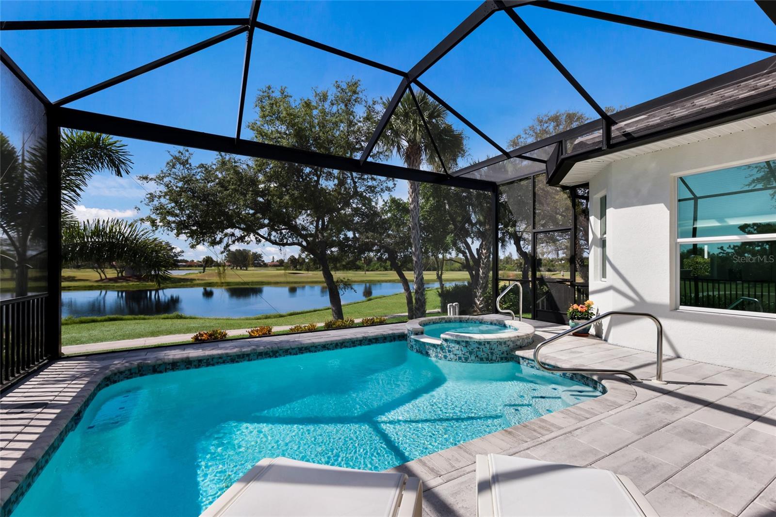 Pool and spa with easy-entry safety rail