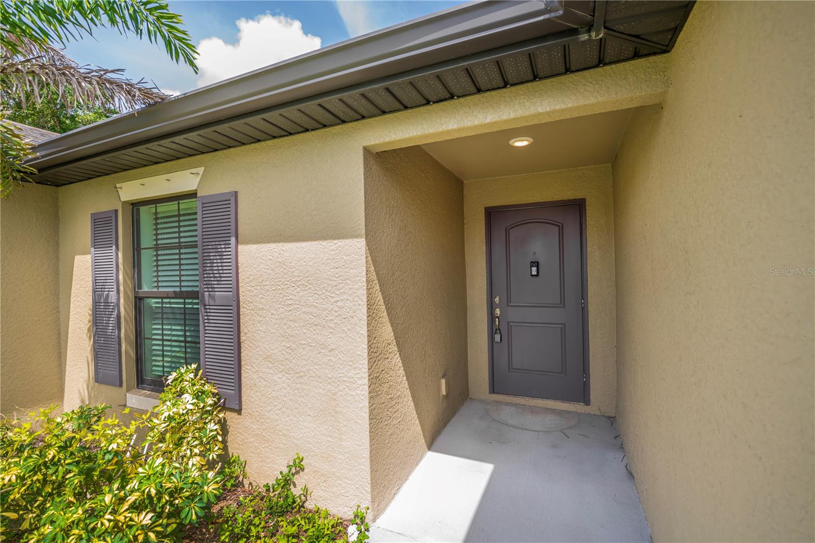 Covered Front Entry with Mature Landscaping