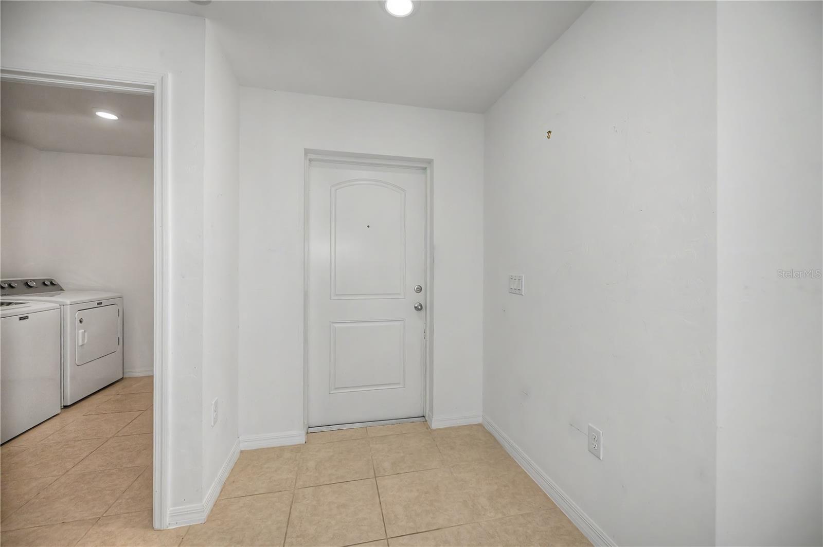 Interior Entryway with Tile Flooring and Nearby Laundry Access