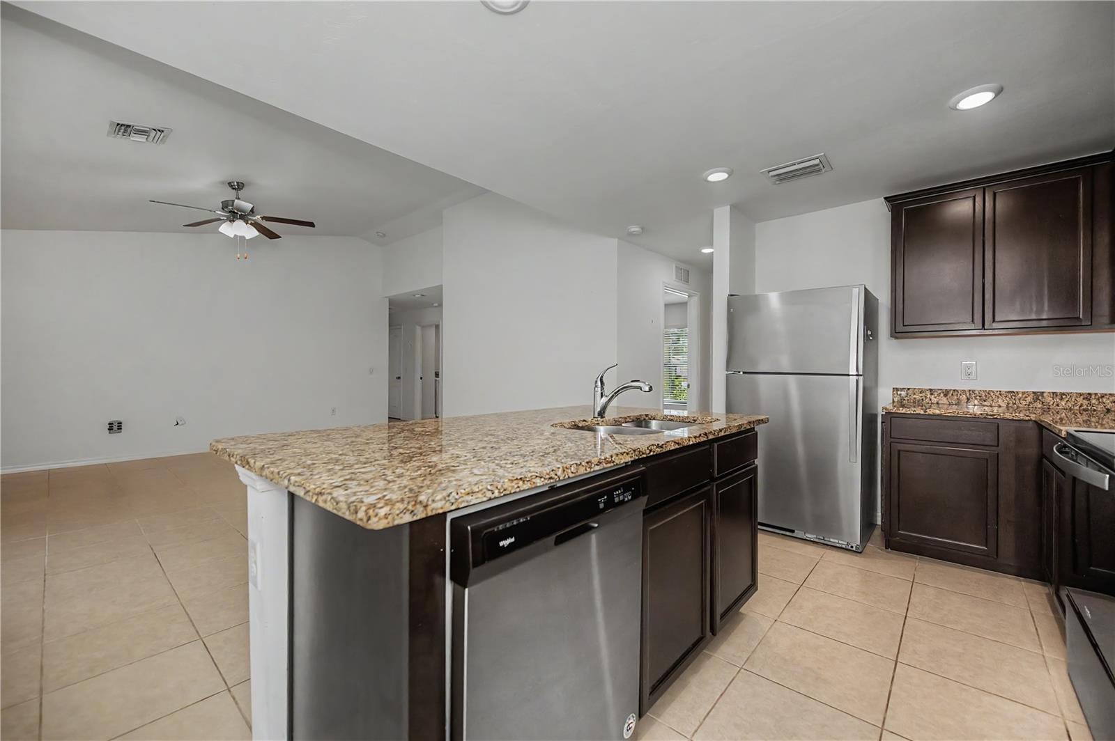 Granite Breakfast Bar with Dark Cabinetry