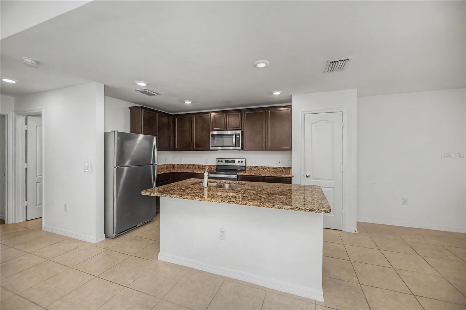 Granite Breakfast Bar with Abundant Cabinetry
