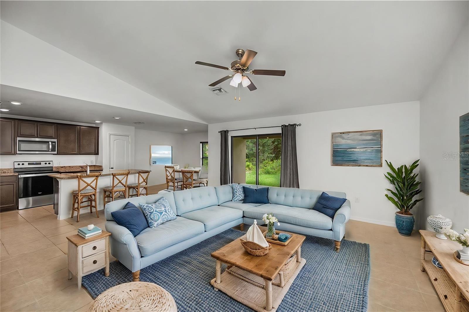 Virtually Staged Open Concept Living Room with Kitchen and Dining Nearby
