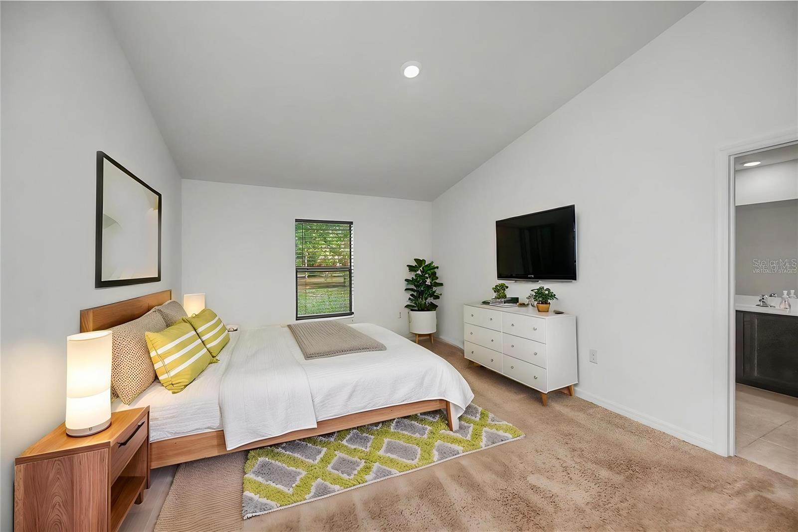Virtually Staged Spacious Primary Bedroom with Ensuite Bath Access