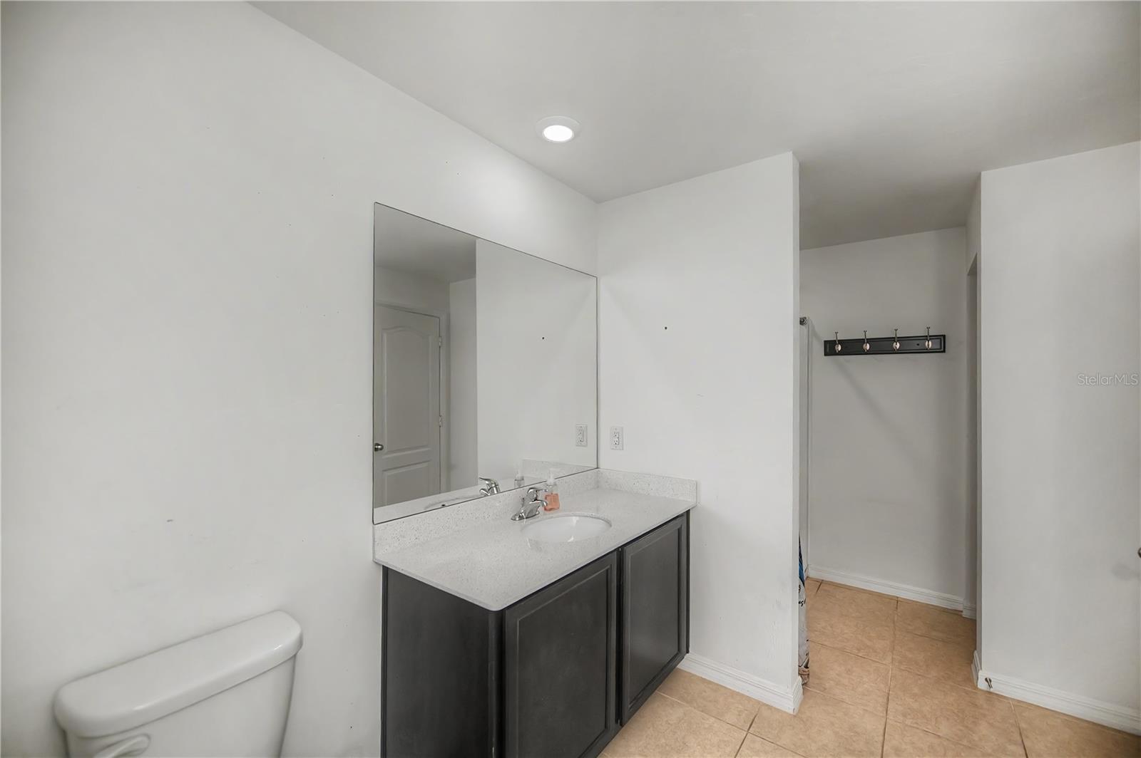Ensuite Bathroom with Oversized Vanity and Tub/Shower Combo