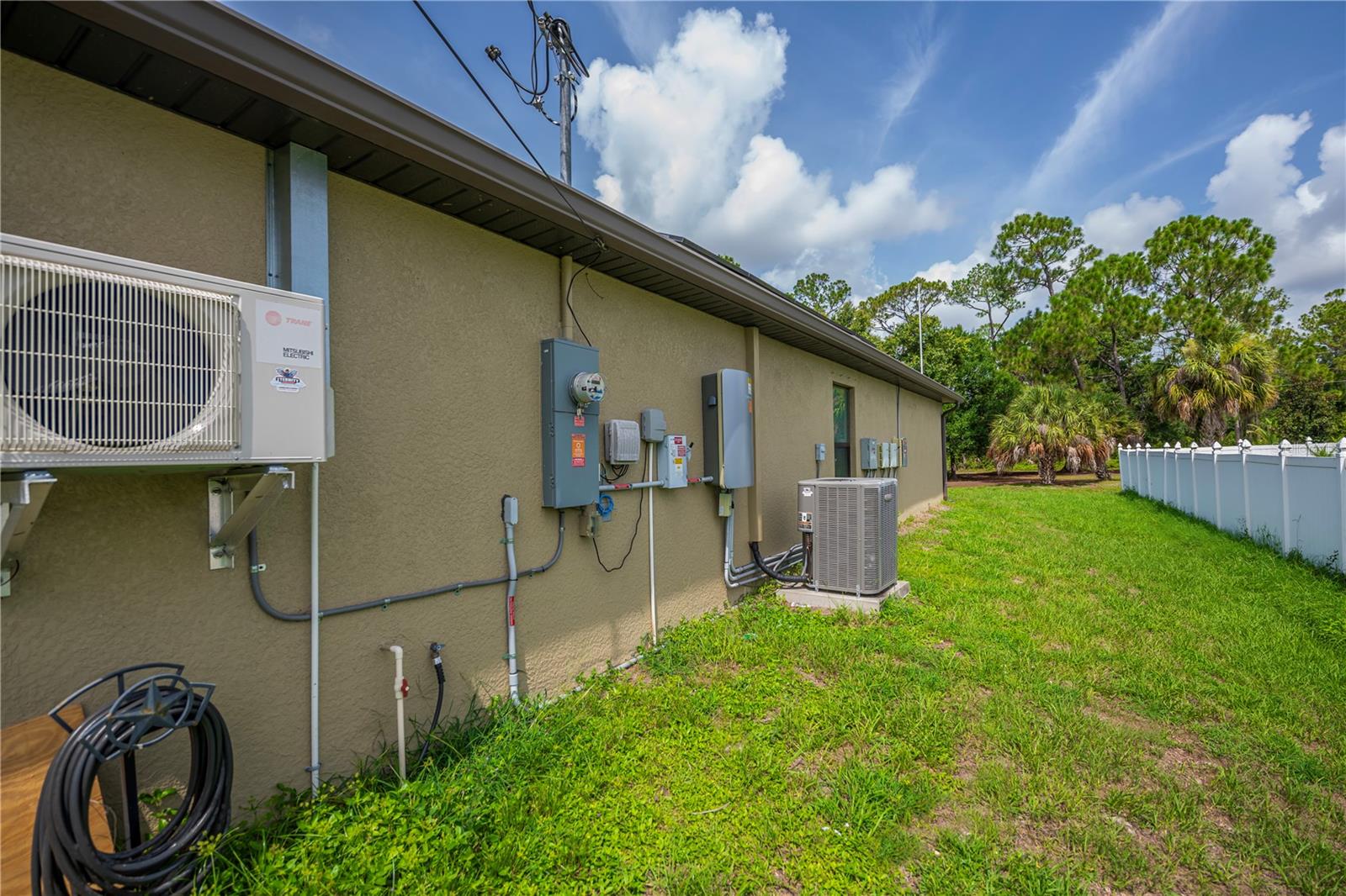 Side Exterior Showcasing A/C Unit and Utility Access