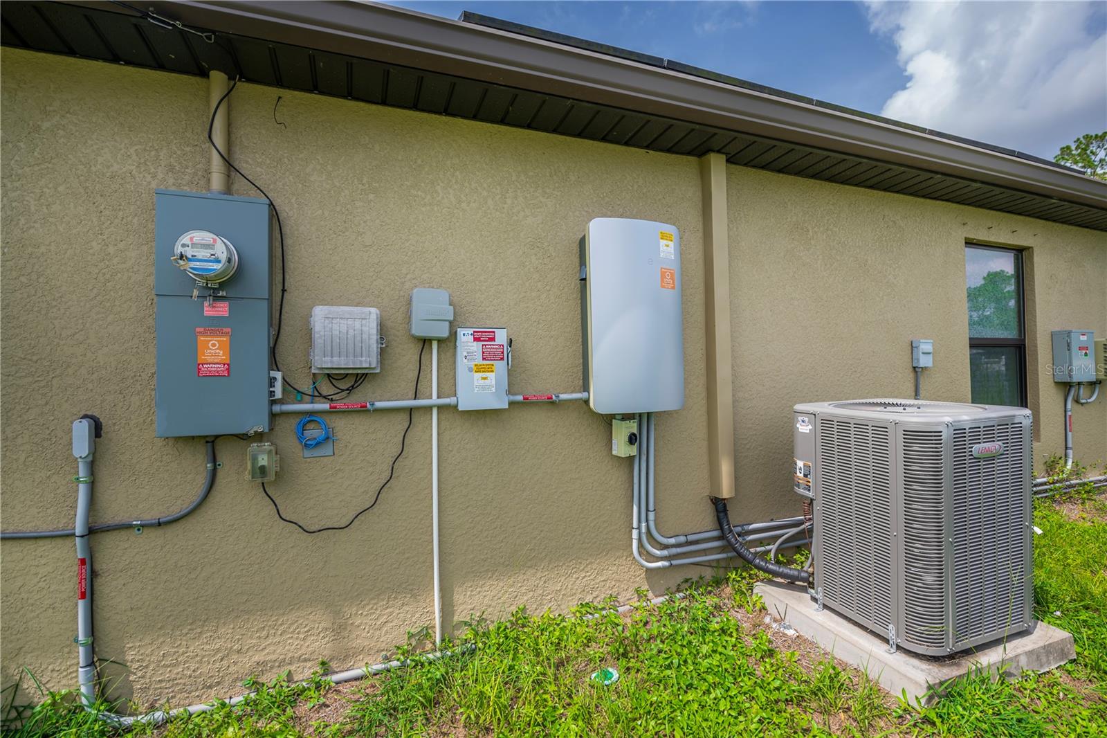 Side Exterior Showcasing A/C Unit and Utility Access