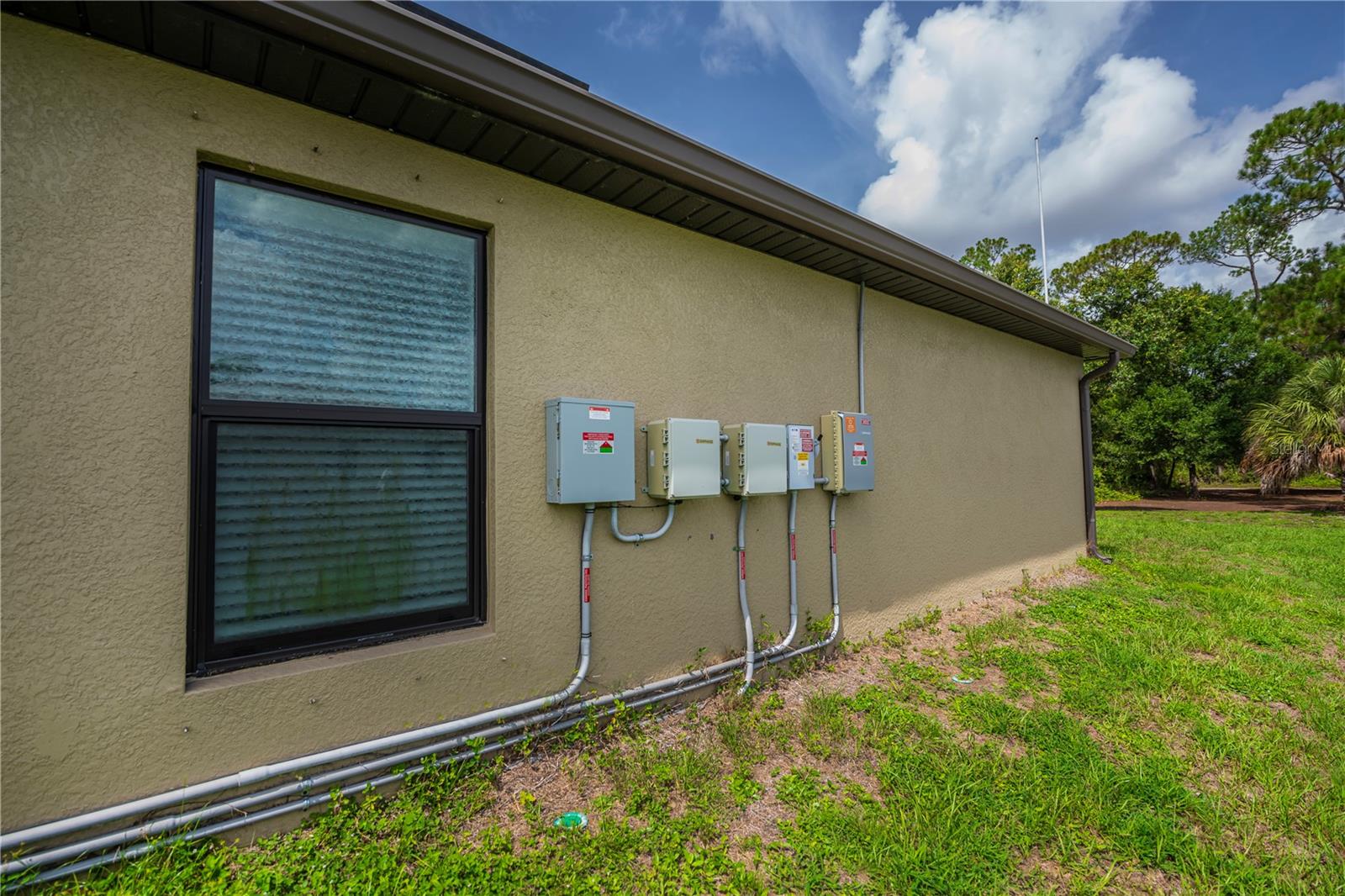 Side Exterior Showcasing A/C Unit and Utility Access