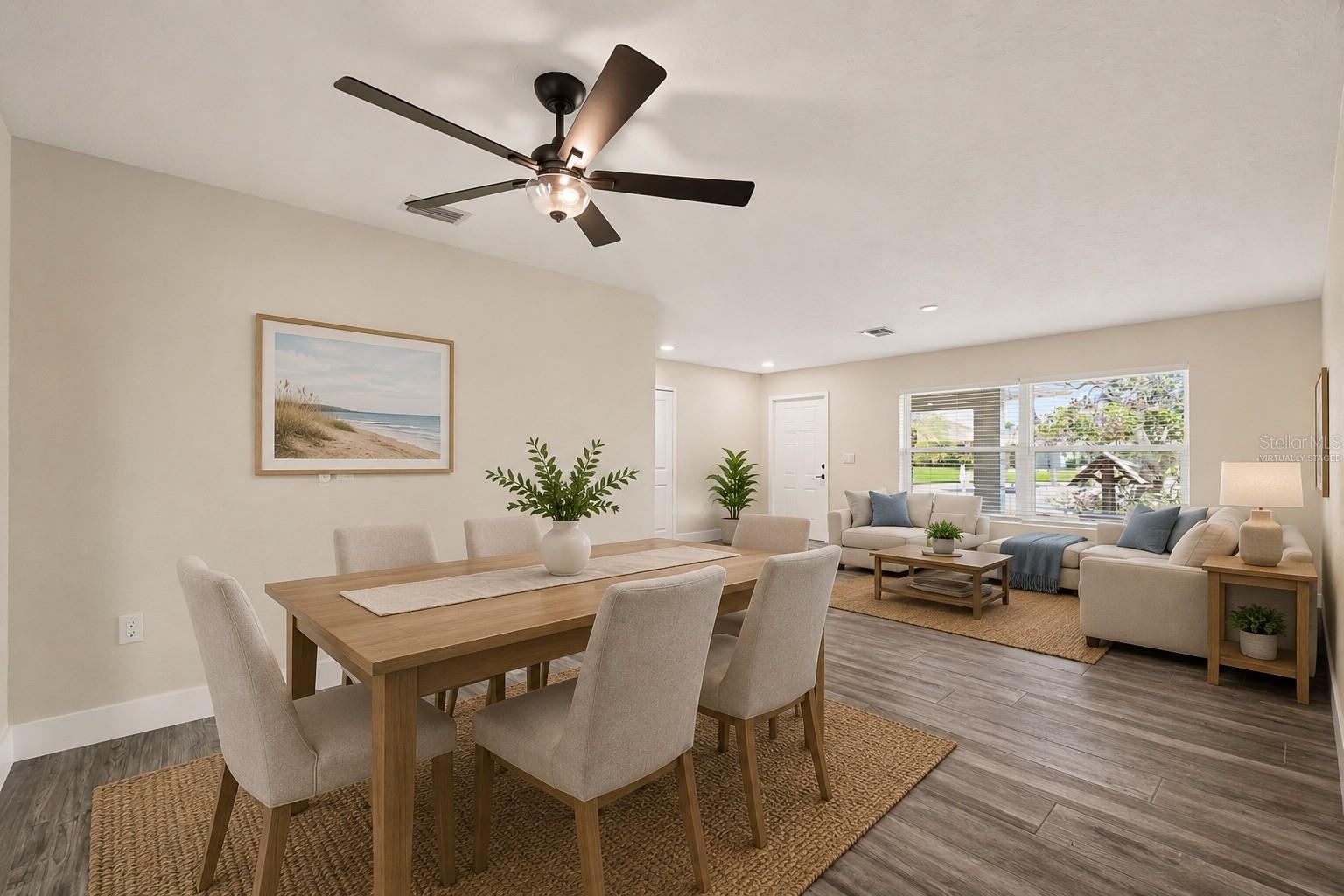 Virtually staged dining room and living room.